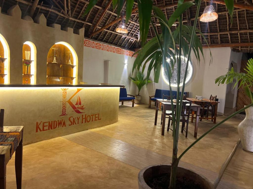 The curved bar counter carrying the hotel's logo, in daylight