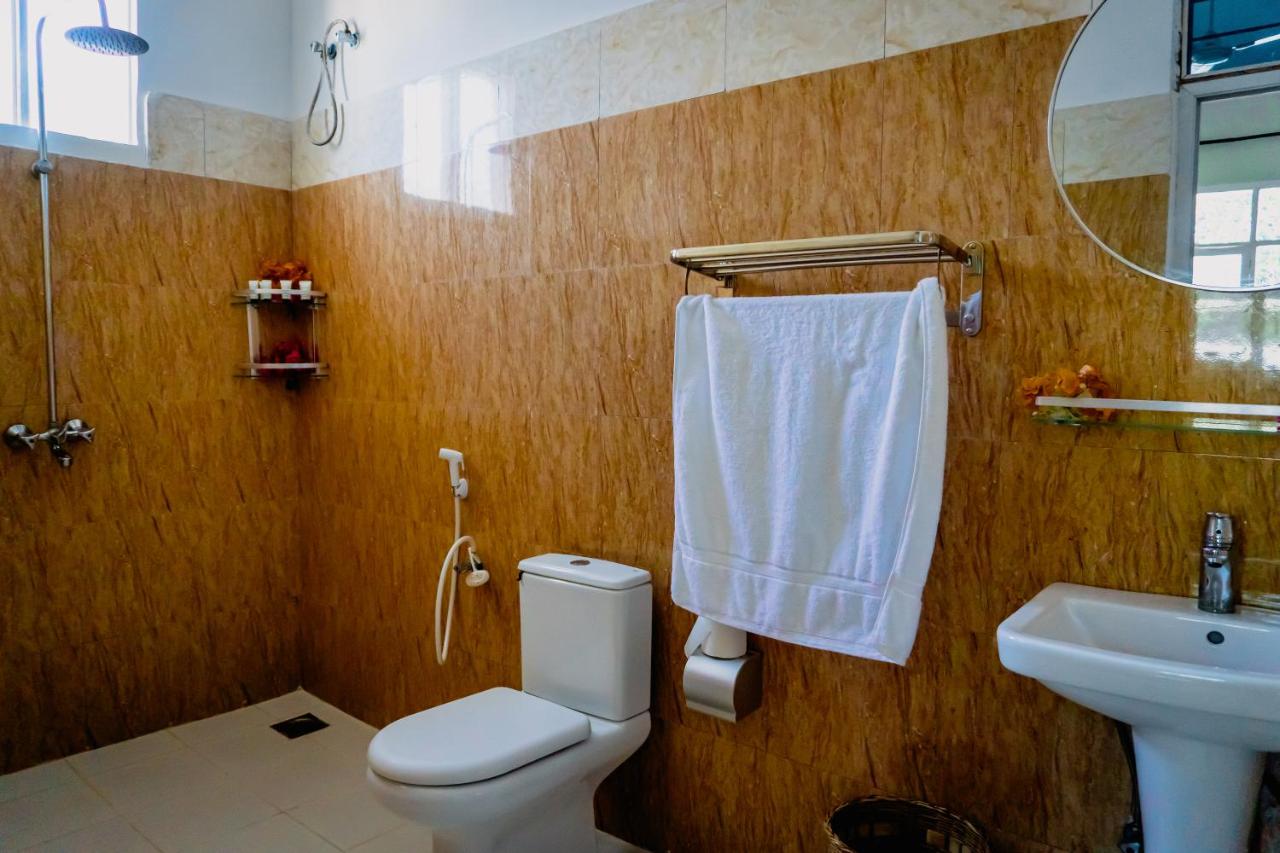 A bathroom with a mirror, basin and toilet