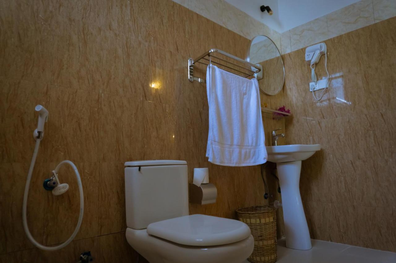 A bathroom with a basin and shower fitting