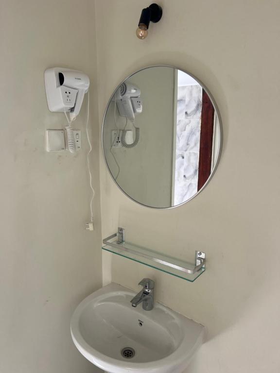 A basin below an oval mirror