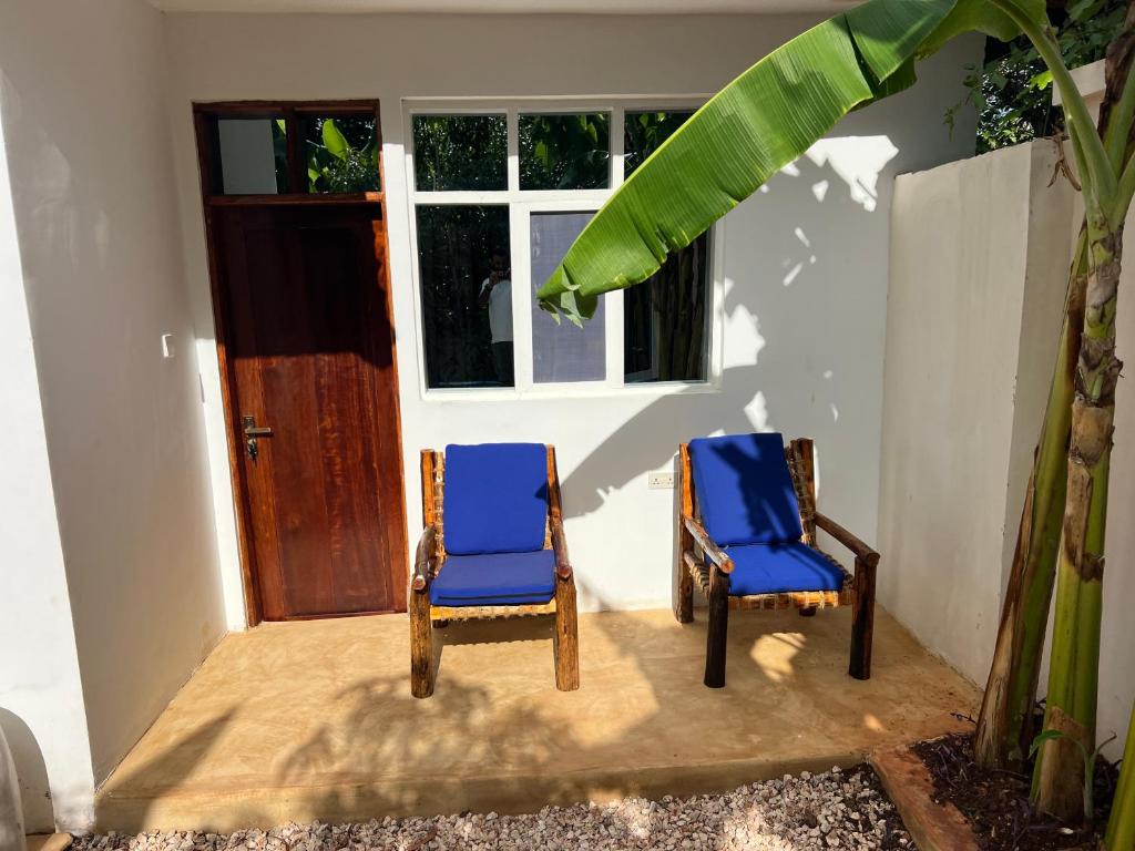 Blue chairs set outside a guest room door