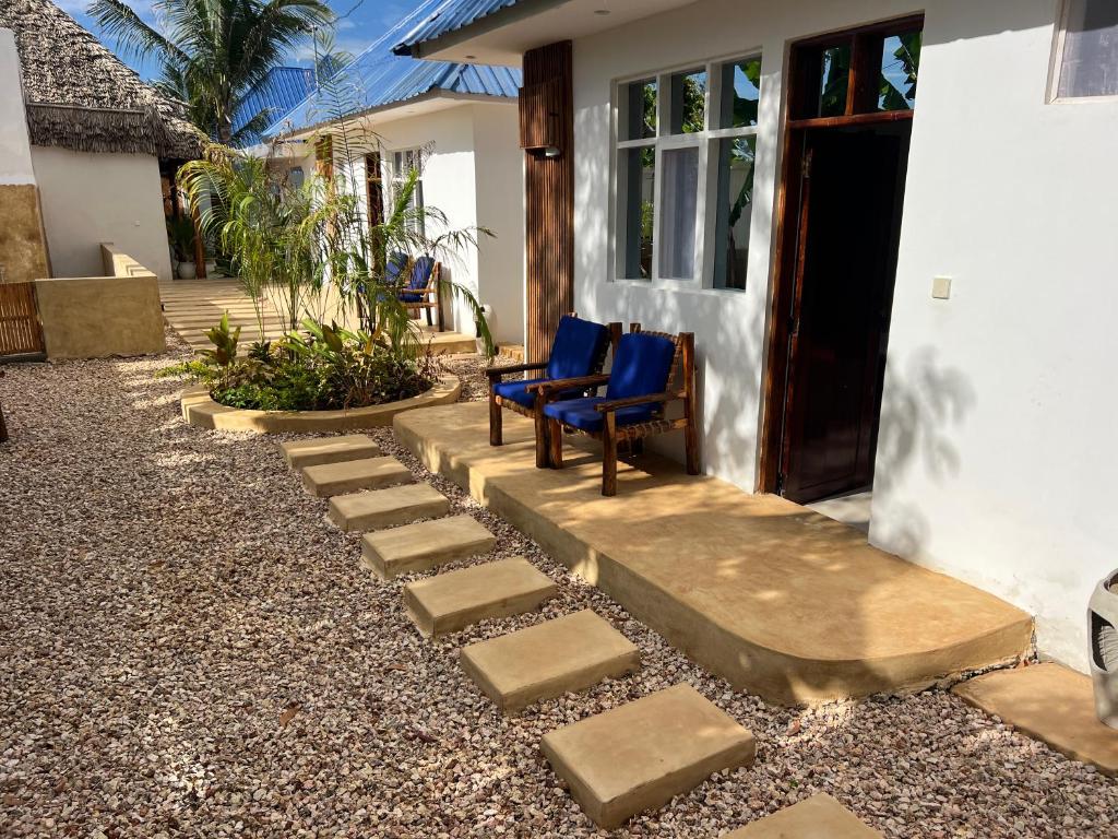 A paved path and steps running out past the guest block