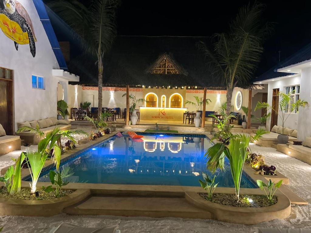 The pool courtyard and thatched bar lit after dark