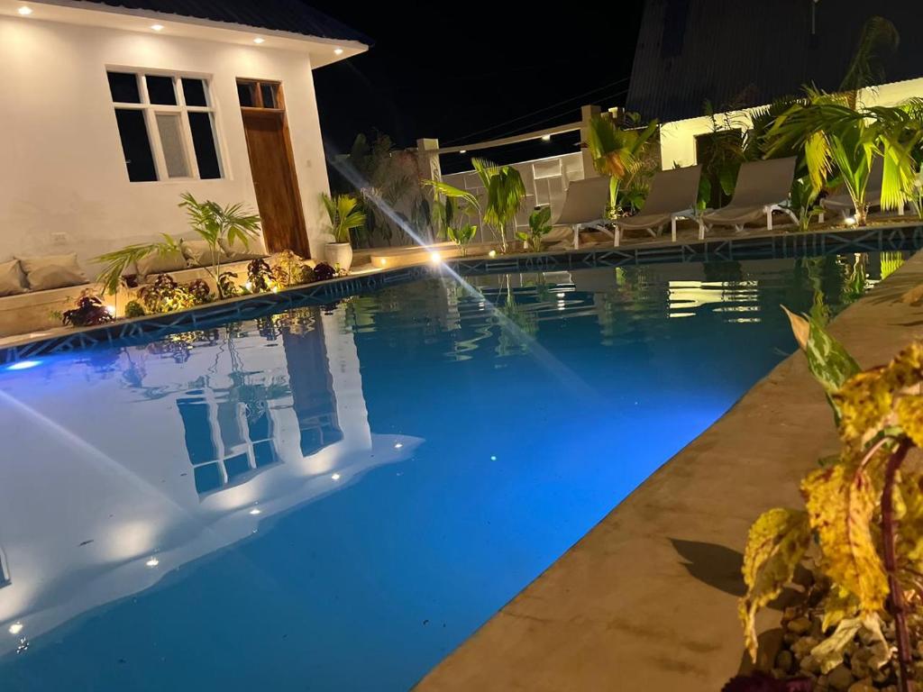 The pool beside the white guest building at dusk