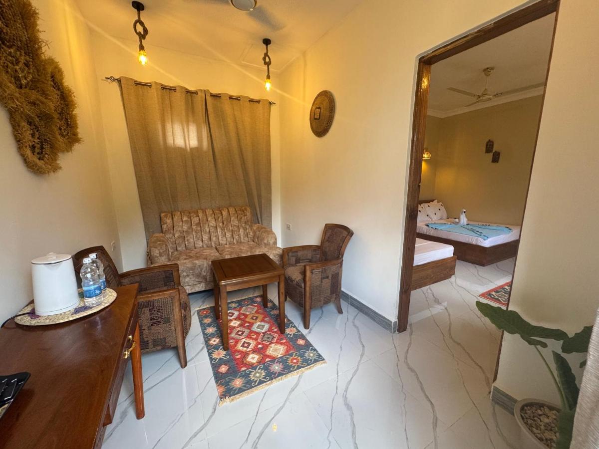 A guest room with curtains, a table and chairs