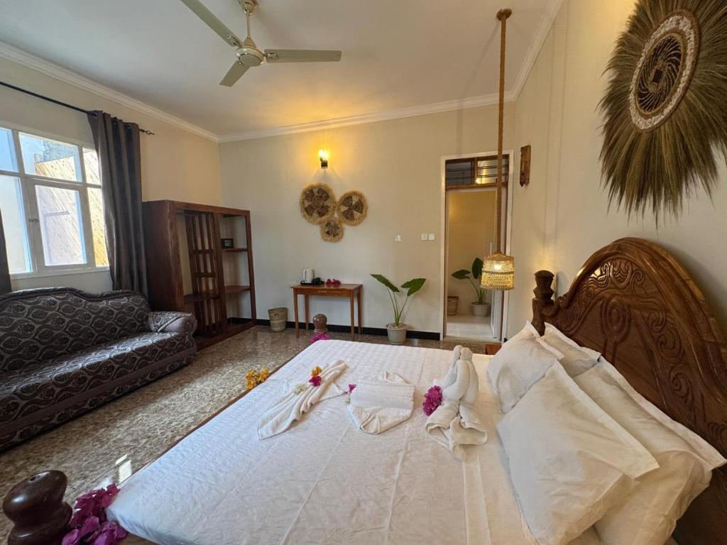 A spacious guest room with a bed and a sofa