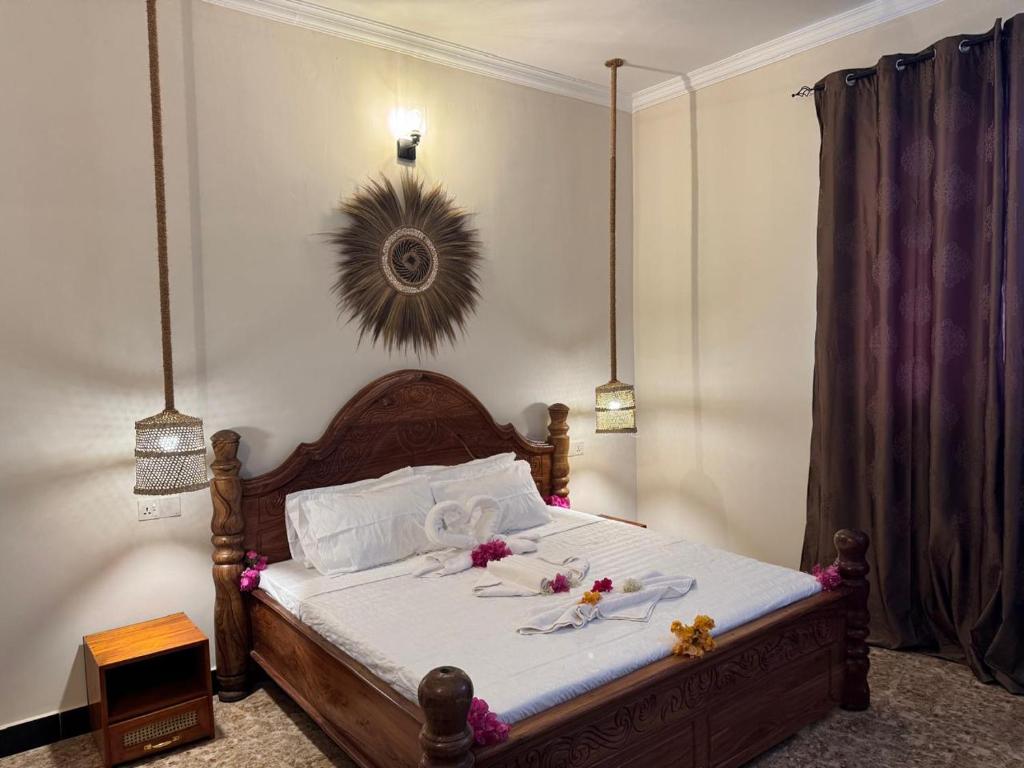 A king bed with an intricately carved wooden headboard