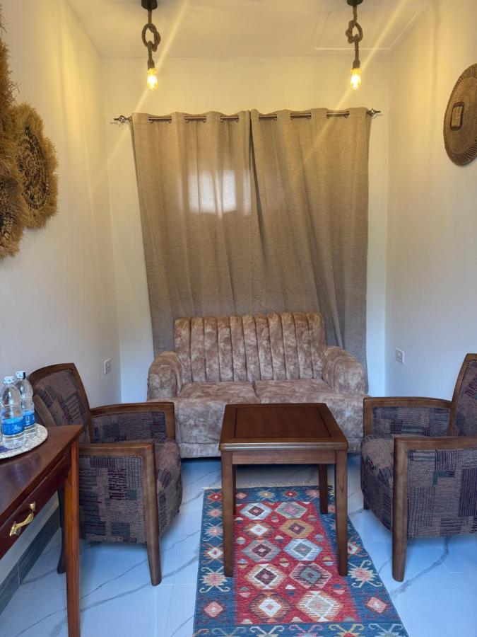 Chairs beside a curtained window in a guest room