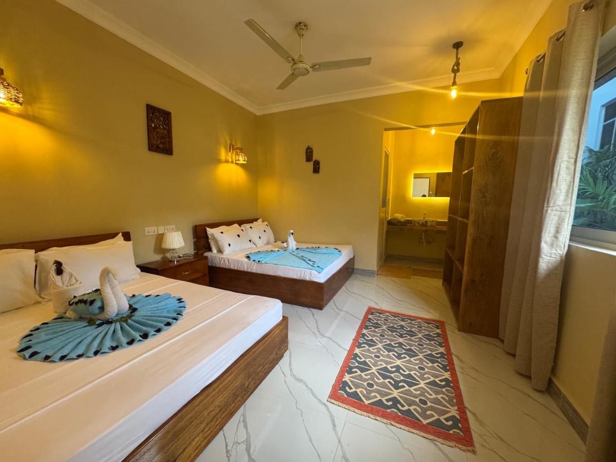 Two single beds beneath a wall light