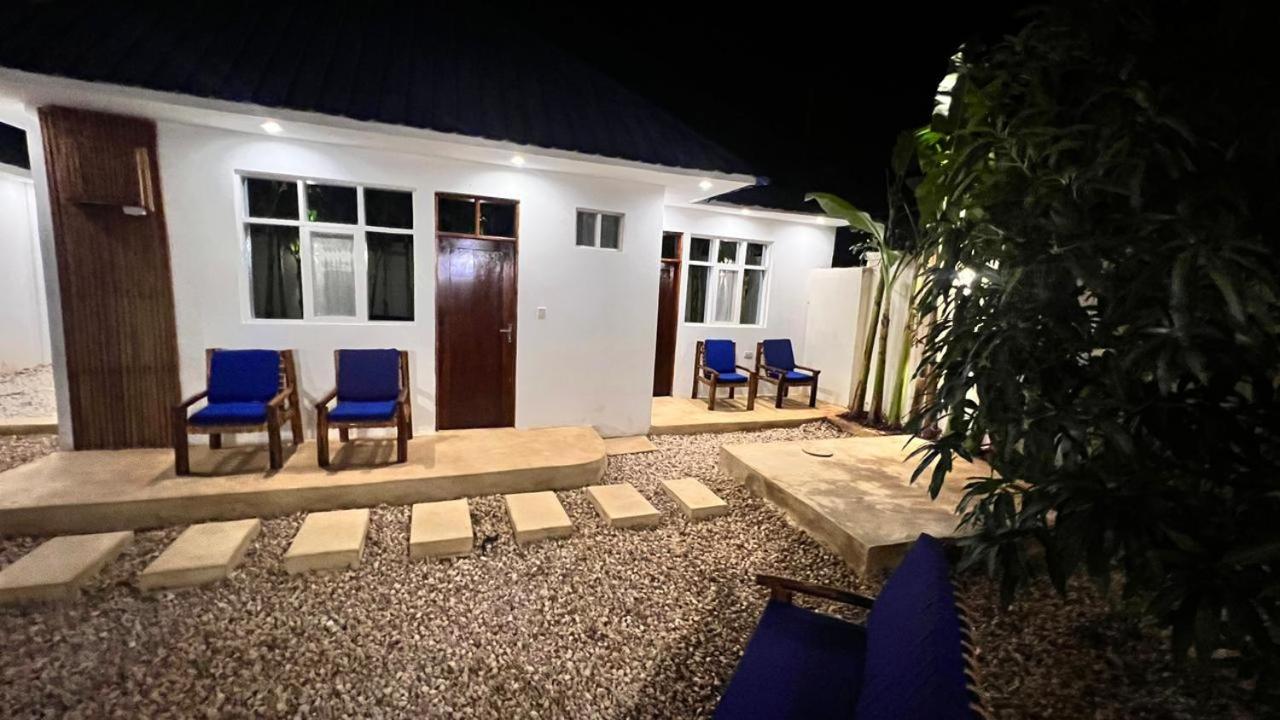 Blue chairs set outside the guest rooms in the evening