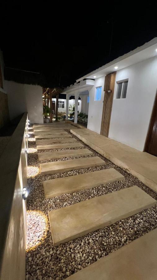 A lit walkway running past the guest room doors